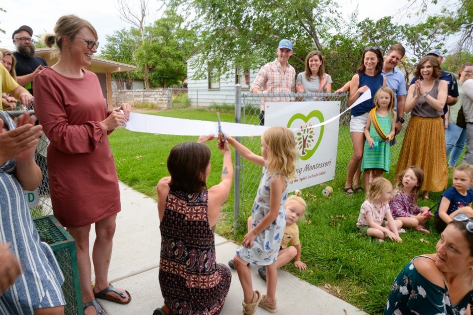 Families gather at HeartSong Montessori in Grand Junction, CO for a ribbon cutting ceremony.